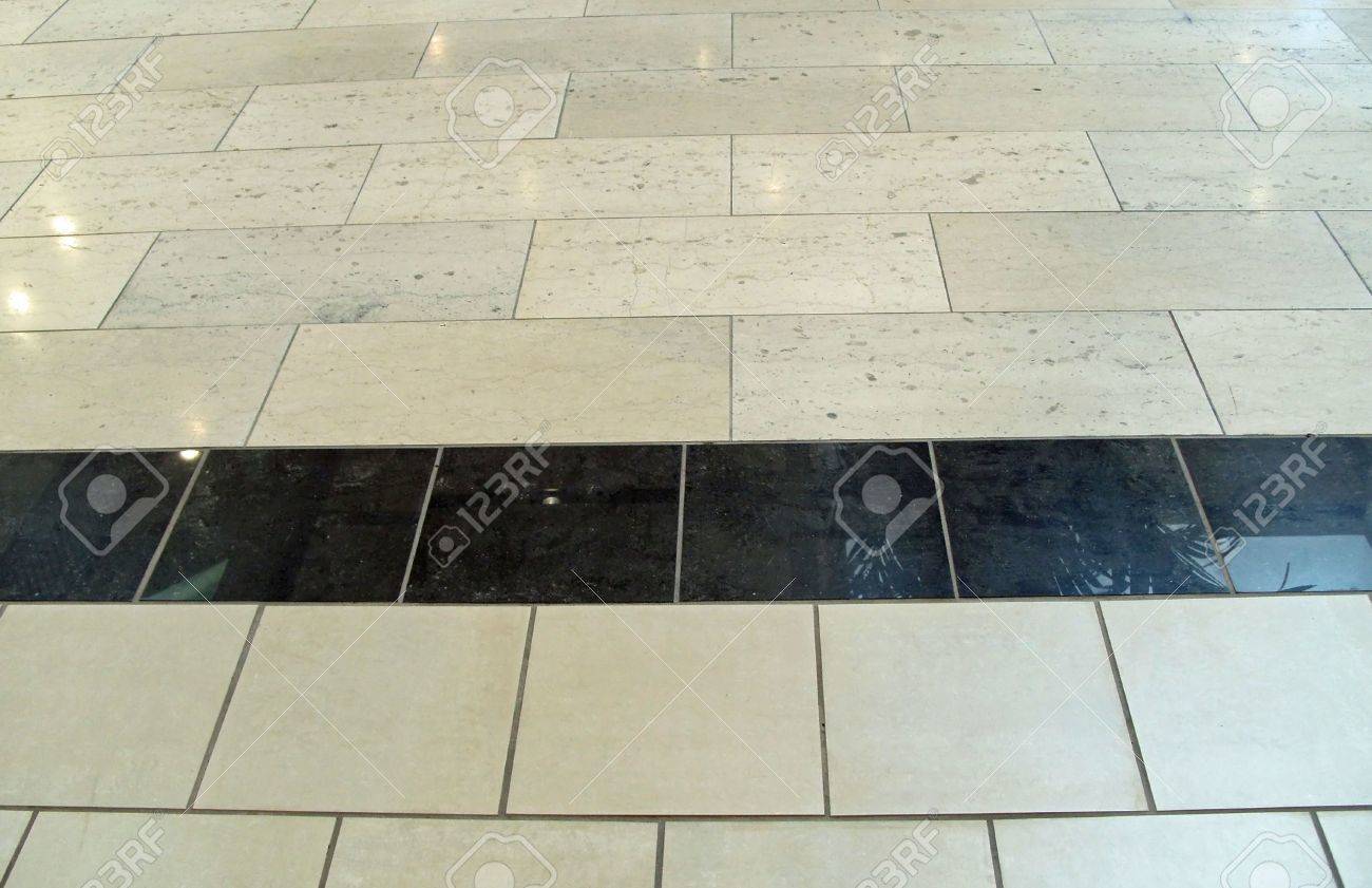 Shining Ceramic Tile Floor With Black Tile Center Stock Photo