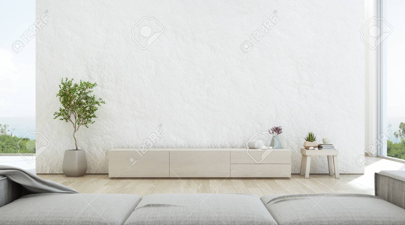 Sea view living room of luxury summer beach house with TV stand and wooden cabinet. Empty rough white concrete wall background in vacation home or holiday villa. Hotel interior 3d illustration. - 103680170 Sea view living room of luxury summer beach house with TV stand and wooden cabinet. Empty rough white concrete wall background in vacation home or holiday villa. Hotel interior 3d illustration. - 103680170