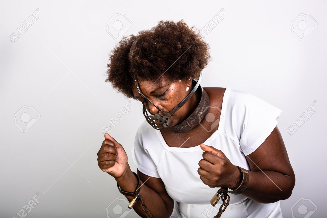 Portrait of a black woman in chains with an iron mask over her mouth.  Slavery in Brazil. Studio reproduction Stock Photo - Alamy