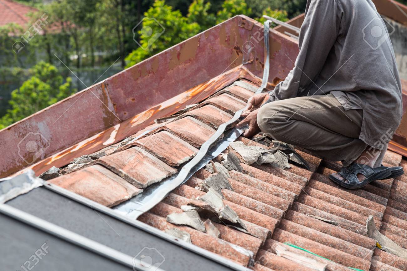 Asian Worker Replacing Roof Tiles And Metal Sheets Of Old Residential Stock Photo Picture And Royalty Free Image Image 97062741