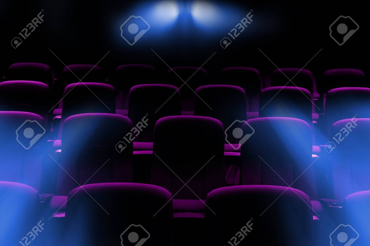 empty movie theater with purple seats with flare light rays from projector - 136321959 empty movie theater with purple seats with flare light rays from projector - 136321959