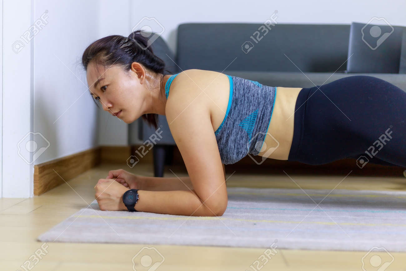 Portrait beautiful adult (40 years old) Asian woman doing Home Workout in Sports Clothing with Stretching Exercise in the room white background. People's body and health care lifestyle concepts. - 166105550 Portrait beautiful adult (40 years old) Asian woman doing Home Workout in Sports Clothing with Stretching Exercise in the room white background. People's body and health care lifestyle concepts. - 166105550