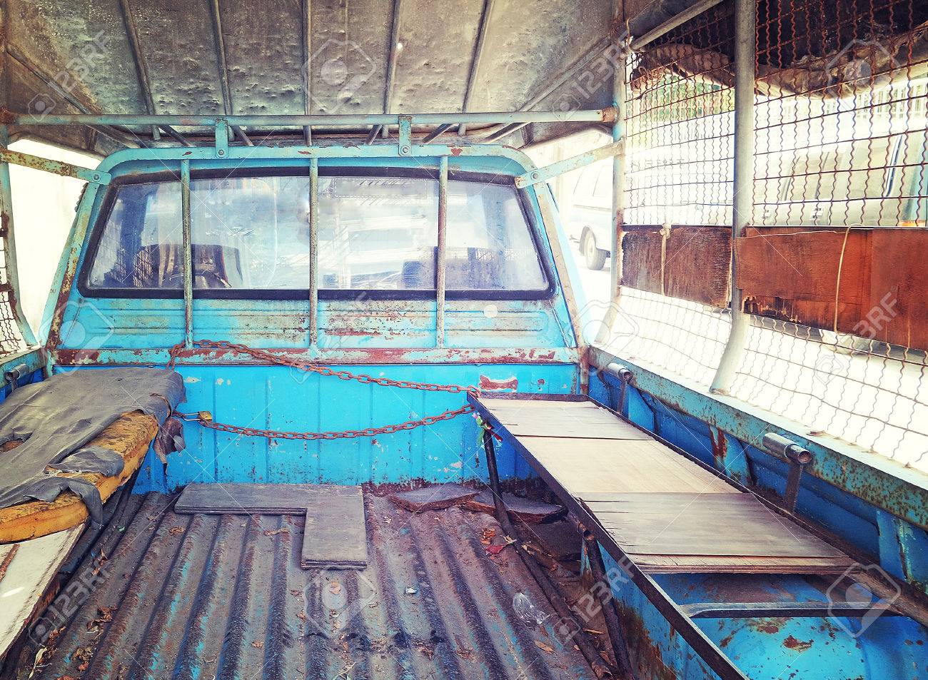 Old Mattress Place Behind Back Of Blue Pickup Truck In Vintage