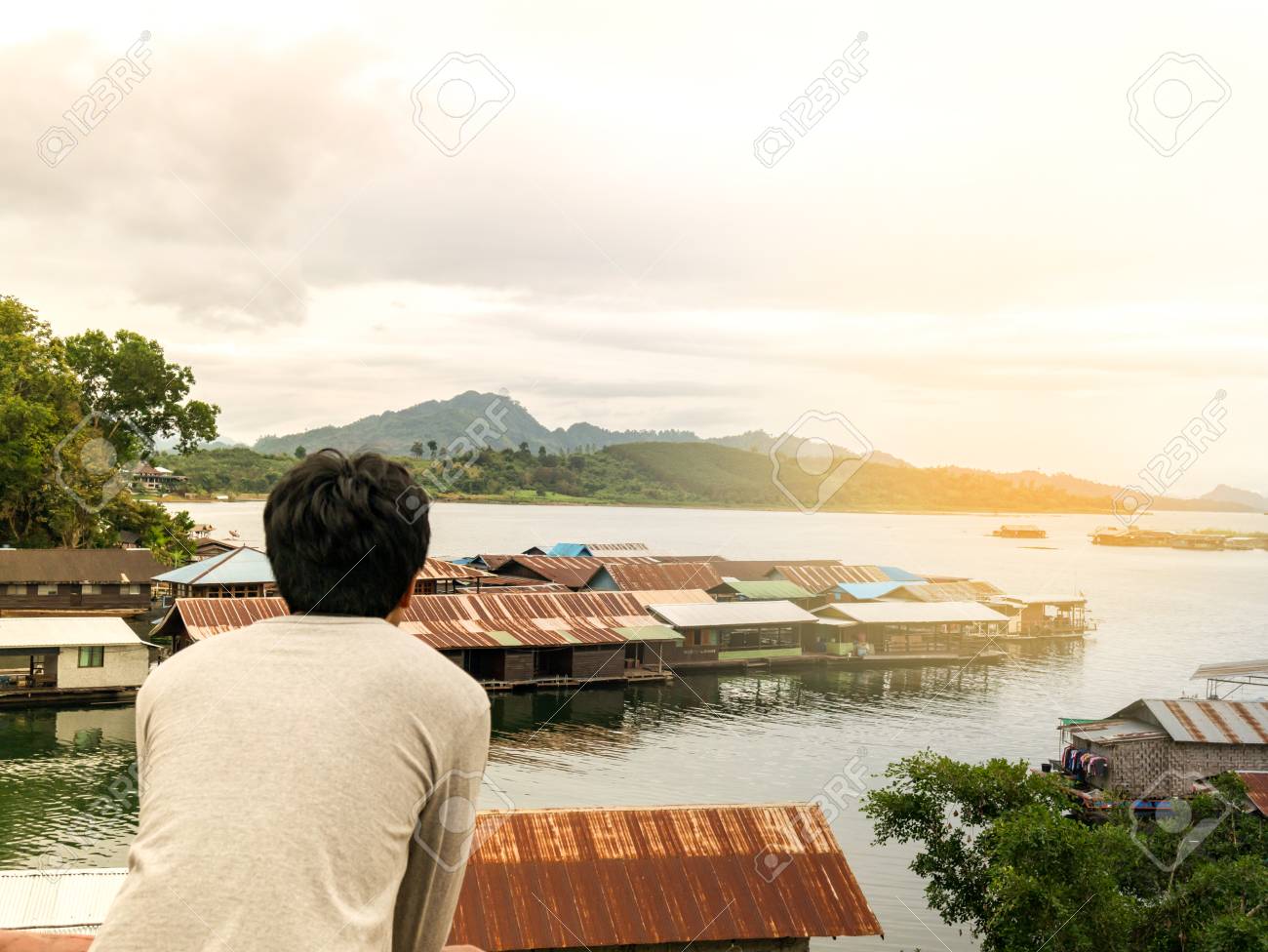 a man standing alone in feeling lonely sad looking and waiting