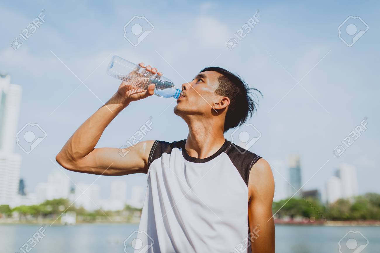 Sports Man Drinking Water After Exercising On Background Of Public Park.  Stock Photo, Picture and Royalty Free Image. Image 73950187., image size:1300x866