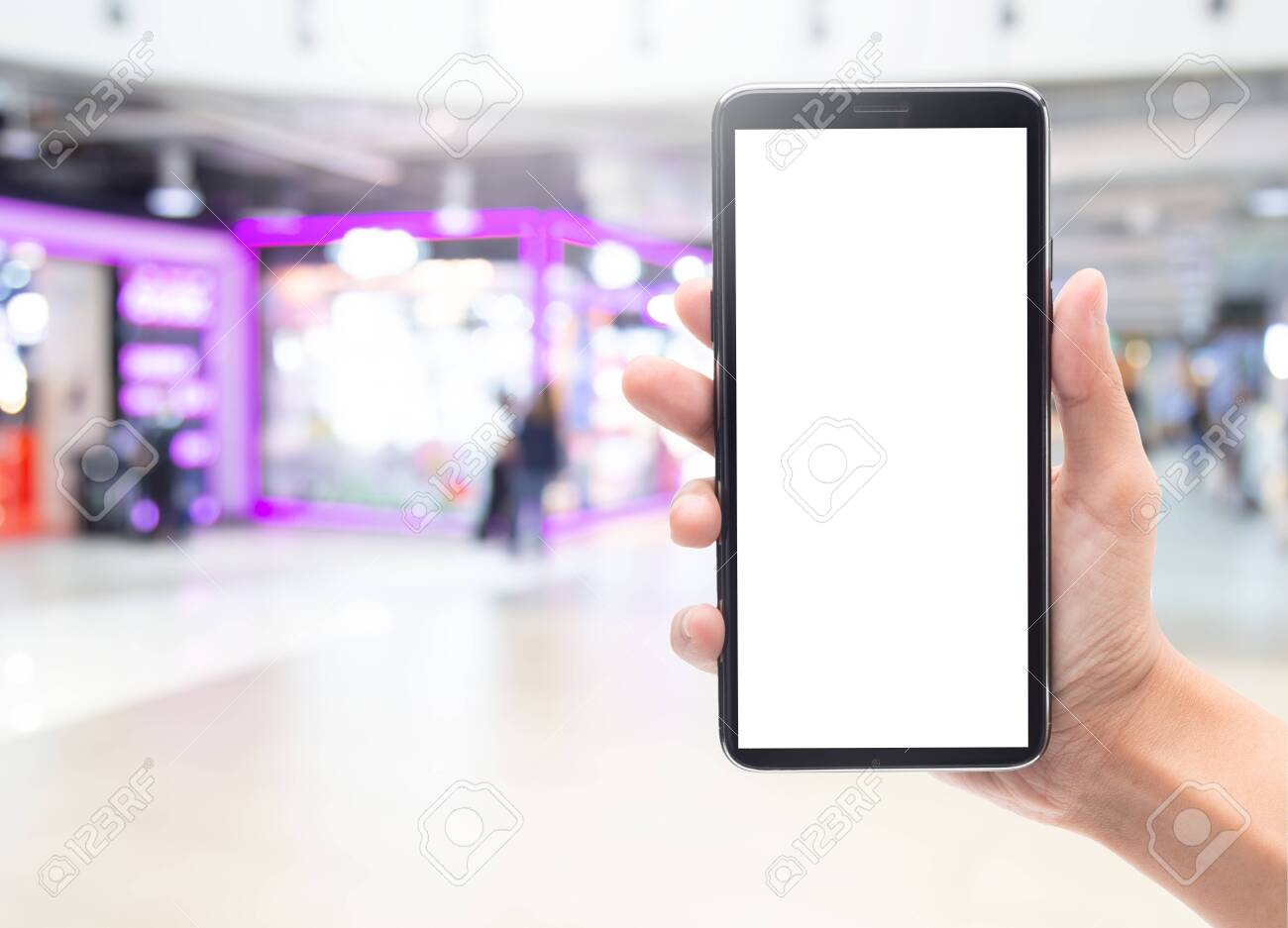 Woman hand holding and touching black smartphone with blank screen mockup template for your design on abstract blur department store or shopping mall. - 145506206 Woman hand holding and touching black smartphone with blank screen mockup template for your design on abstract blur department store or shopping mall. - 145506206