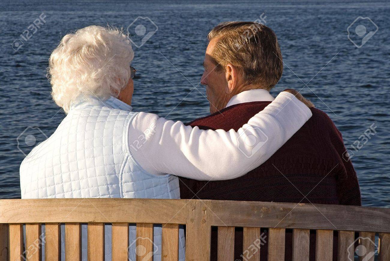 Caring couple sitting and enjoying the sunset - 9385789 Caring couple sitting and enjoying the sunset - 9385789