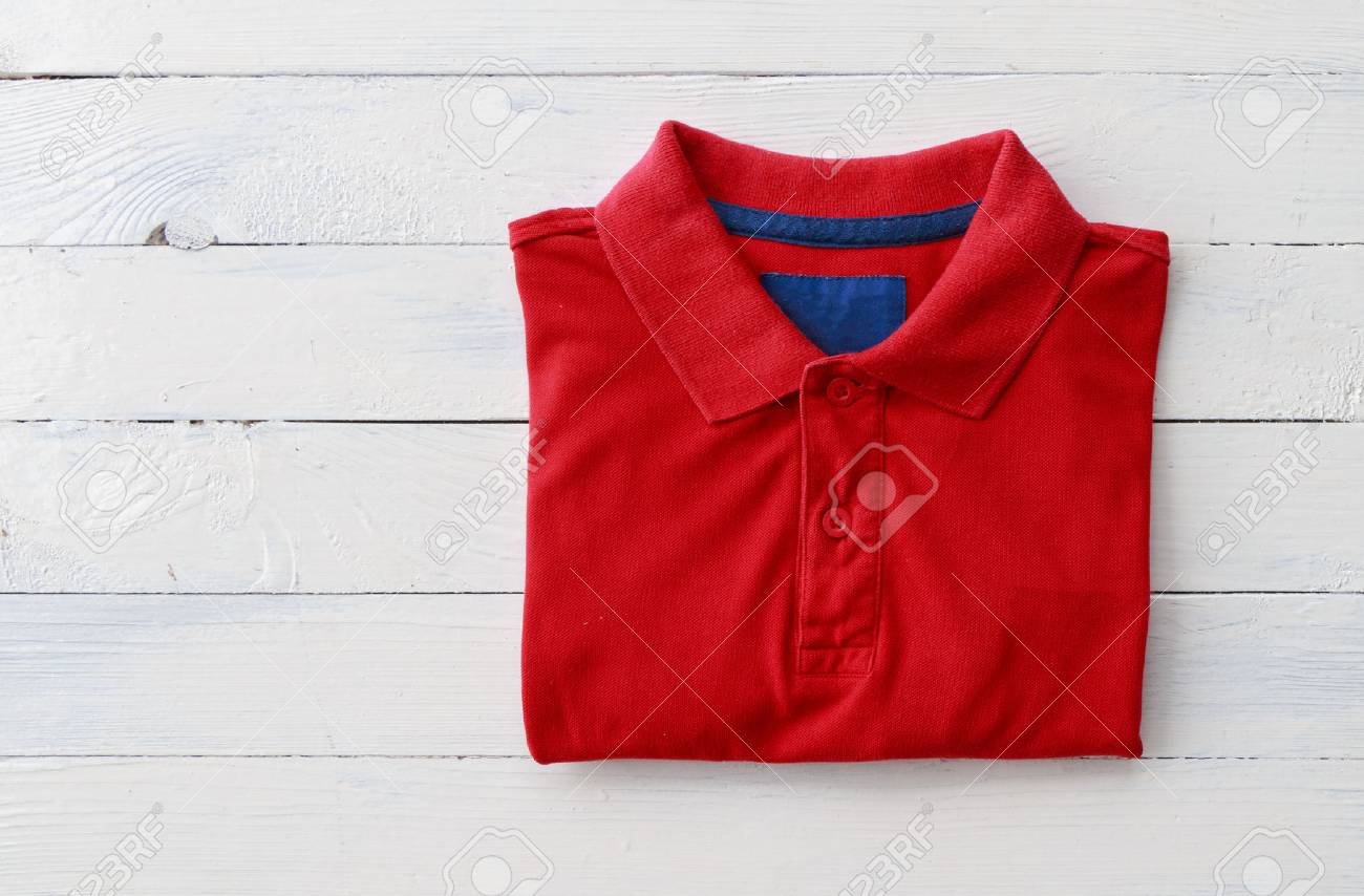 Close up top view of man polo shirt put on rustic wooden table top with blank space use for texts display - 89534353 Close up top view of man polo shirt put on rustic wooden table top with blank space use for texts display - 89534353