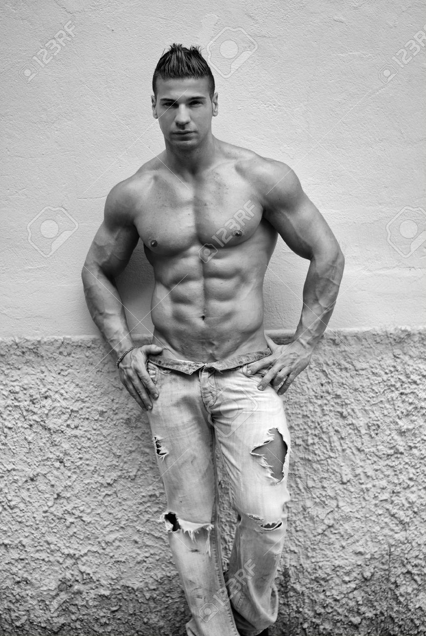 26228583-attractive-young-man-shirtless-with-jeans-leaning-against-a-wall-black-and-white-shot-Stock-Photo.jpg
