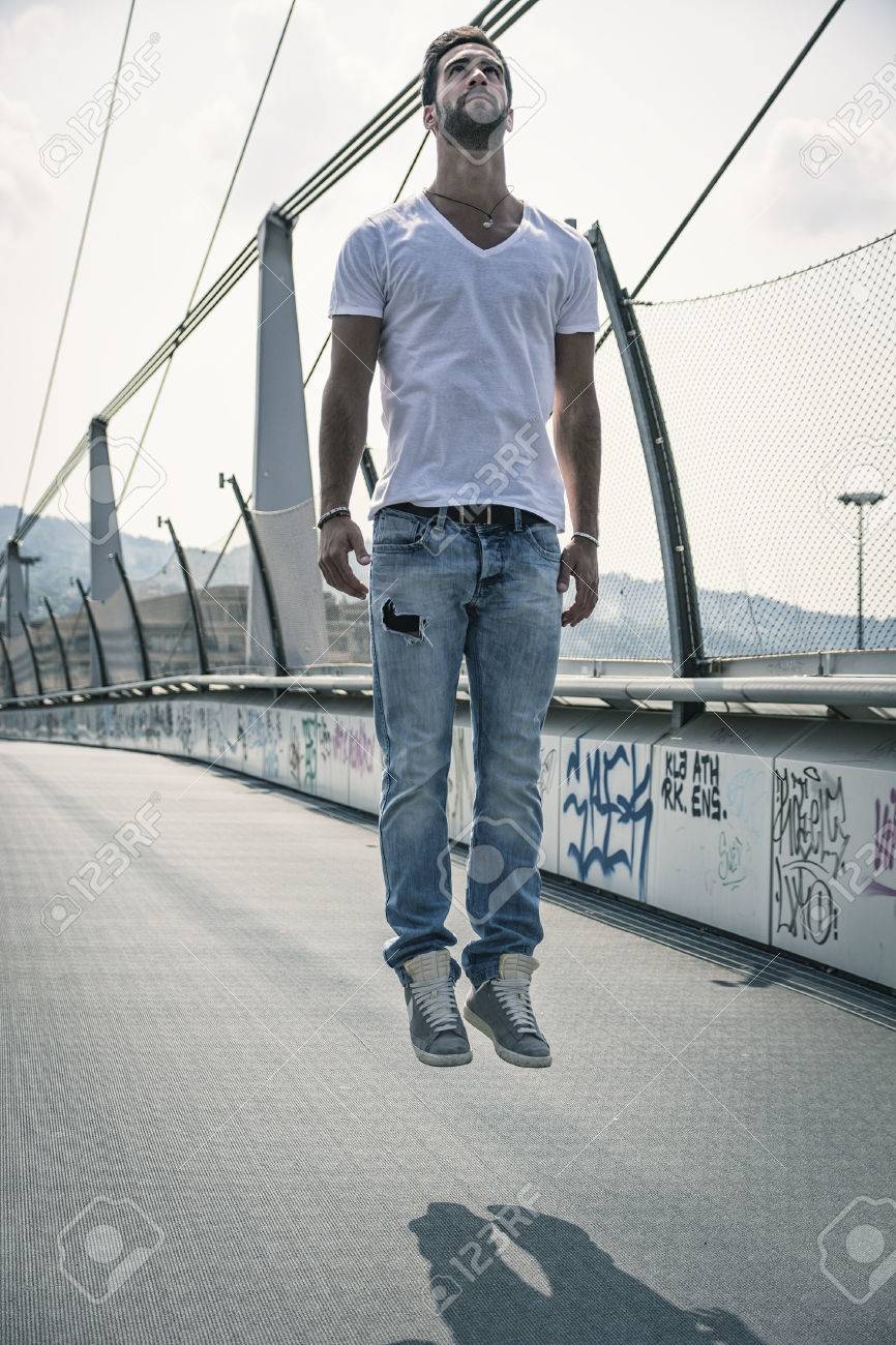 handsome young man levitating