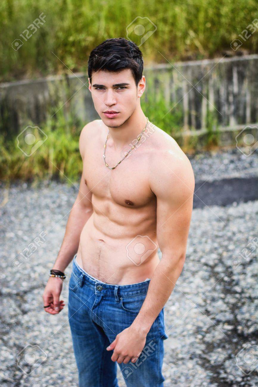 41153240-Shirtless-sexy-muscular-young-man-in-jeans-walking-along-rural-road-Stock-Photo.jpg