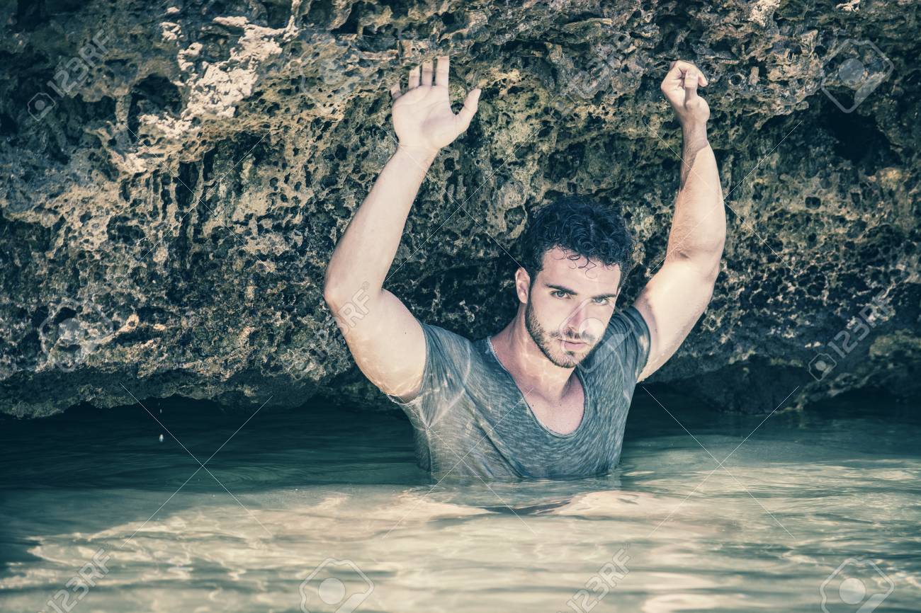 Привлекательный Молодой Спортивный Человек В Море Или Океане Скалистом  Берегу, Носить Мокрые Футболки, СЭУС Выражение Фотография, картинки,  изображения и сток-фотография без роялти. Image 56951758