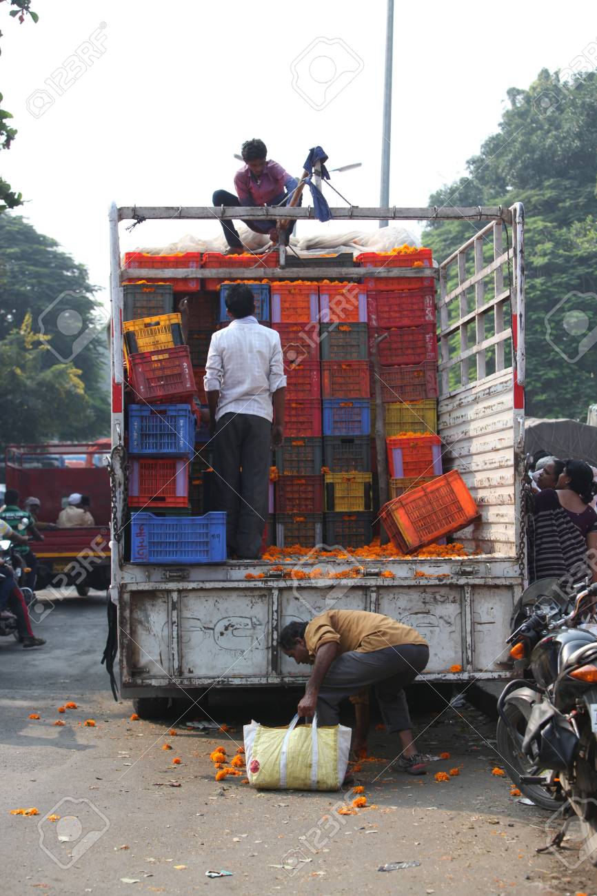 Pune India October 21 2015 Farmers Unloading Boxes Of Marigold Flowers For Sale On The Eve Of Dassera Festival In Which These Flowers Are Traditionally Used Stock Photo Picture And Royalty