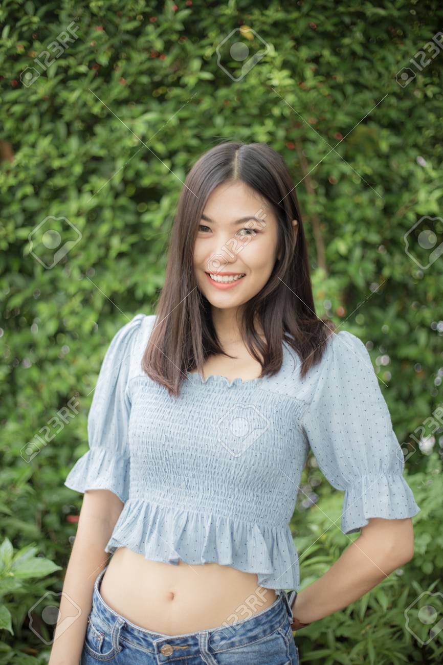 Beautiful Asain Women Stand In Front Of Green Leaf Background, Fashion  Women Stock Photo, Picture and Royalty Free Image. Image 124894719.