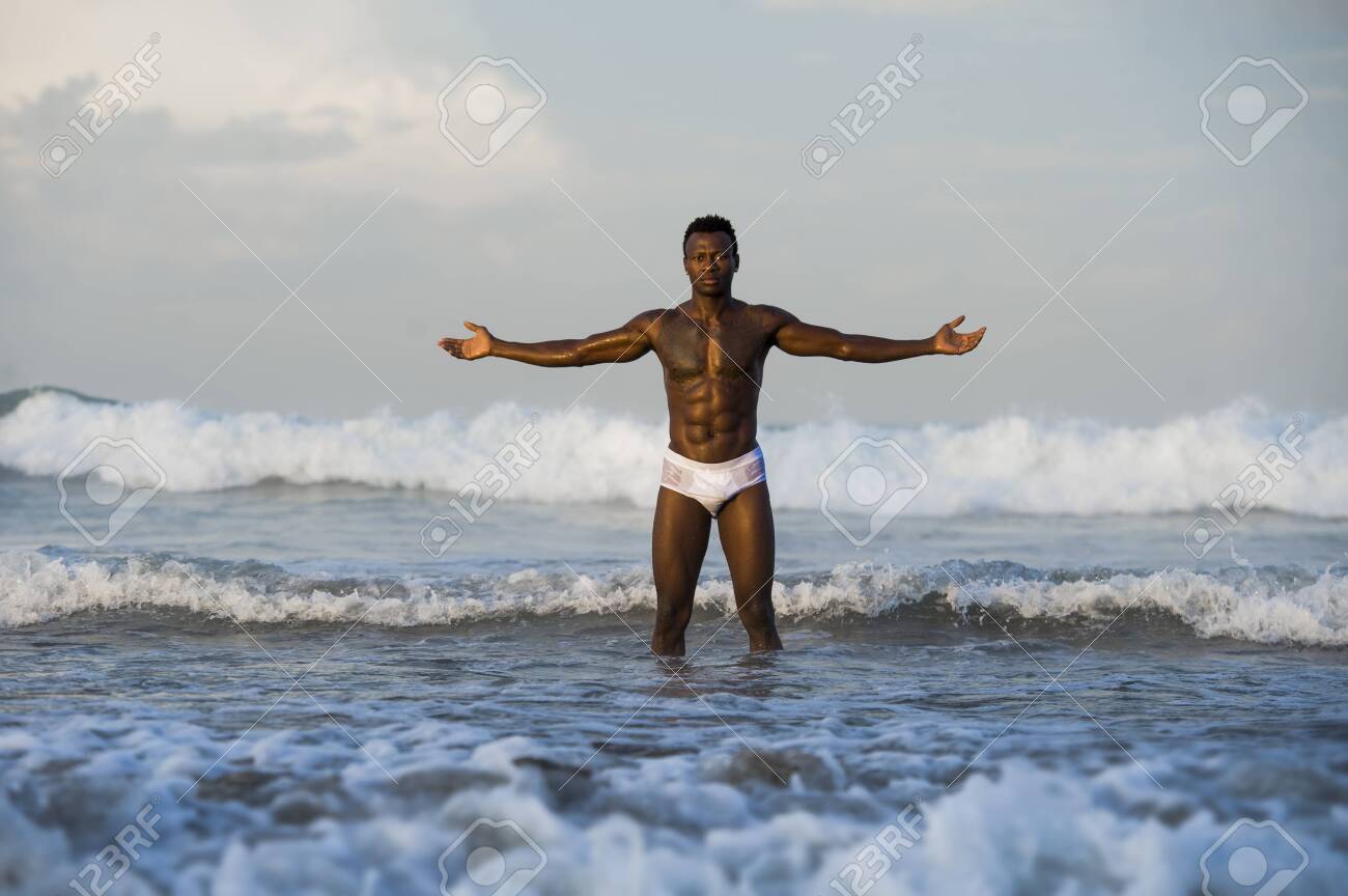 Artistic Portrait Of Young Attractive And Fit Black African American Man  With Sexy Muscular Body And Six Pack Abs Opening Arms Free On Beach With  Big Sea Waves In Beauty And Health, image size:1300x864