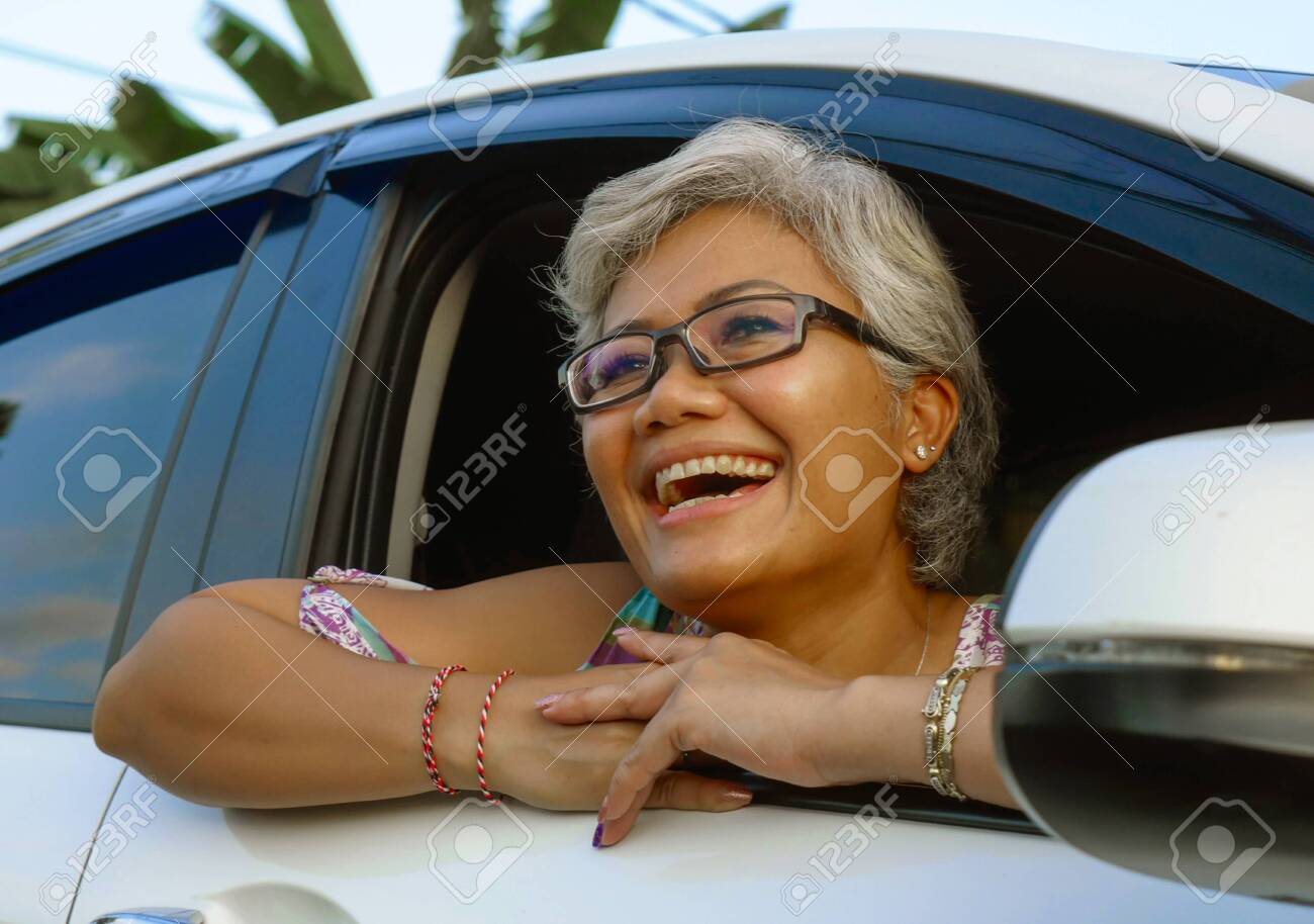 Lifestyle Portrait Of Attractive And Happy Middle Aged Asian