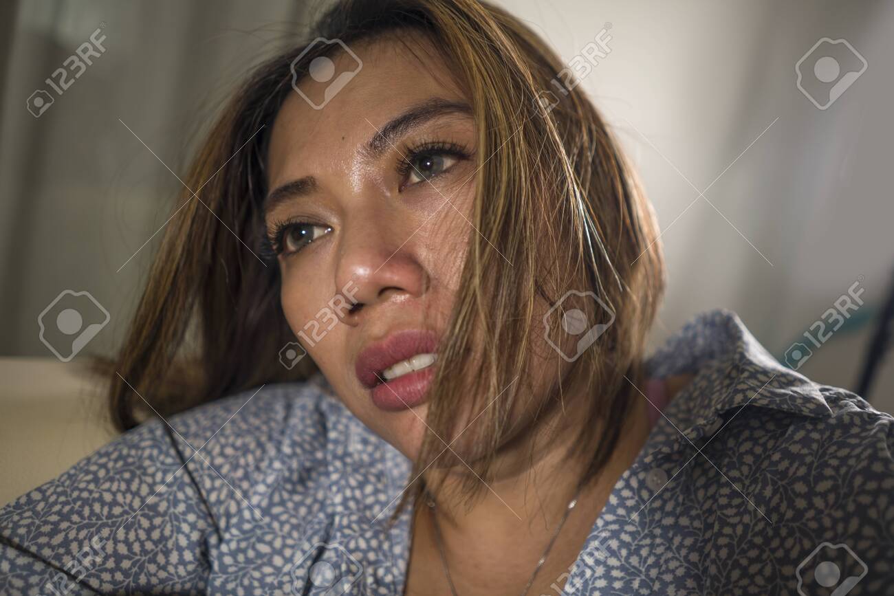 dramatic lifestyle portrait of young beautiful sad and depressed woman thoughtful and confused at home couch feeling broken heart suffering depression crisis and anxiety problem - 128301360 dramatic lifestyle portrait of young beautiful sad and depressed woman thoughtful and confused at home couch feeling broken heart suffering depression crisis and anxiety problem - 128301360