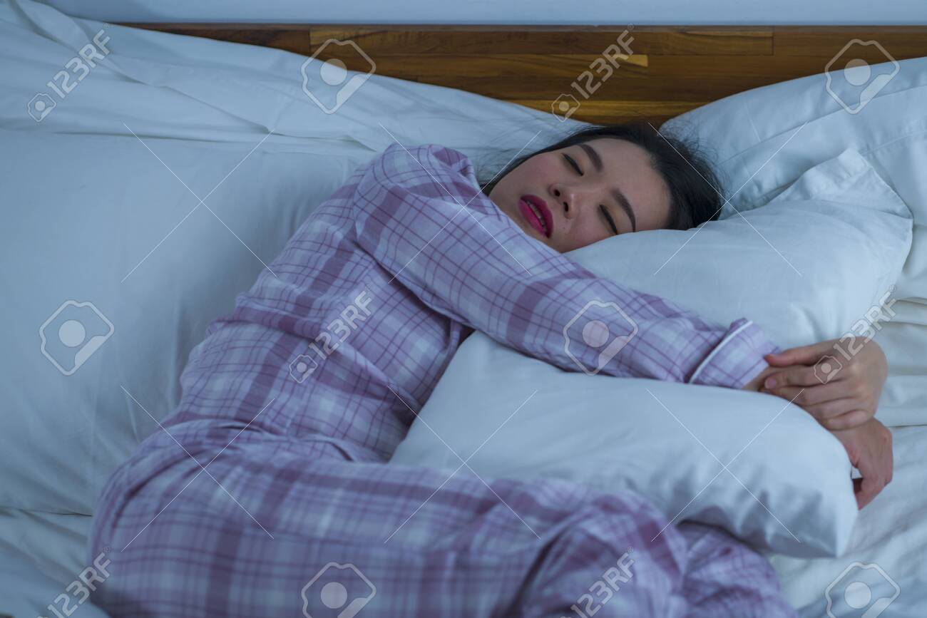Lifestyle Portrait Of Young Beautiful And Sweet Asian Korean Girl On Her 20s Alone At Home Sleeping Relaxed Wearing Pajamas Lying On Bed Happy And Comfortable Resting And Dreaming Stock Photo Picture