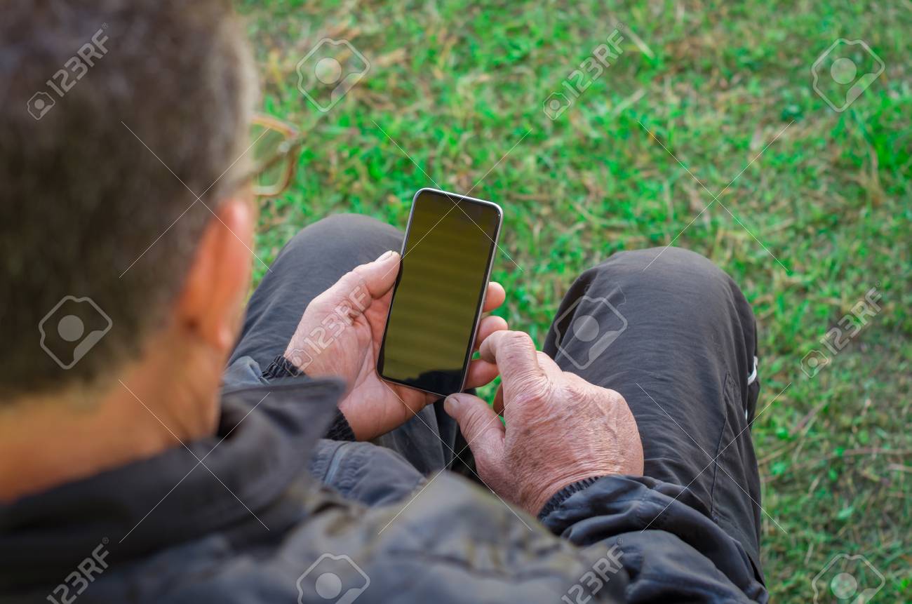 Close up of a wrinkled finger touching the smartphone, old man uses technology. Internet. - 98260331 Close up of a wrinkled finger touching the smartphone, old man uses technology. Internet. - 98260331