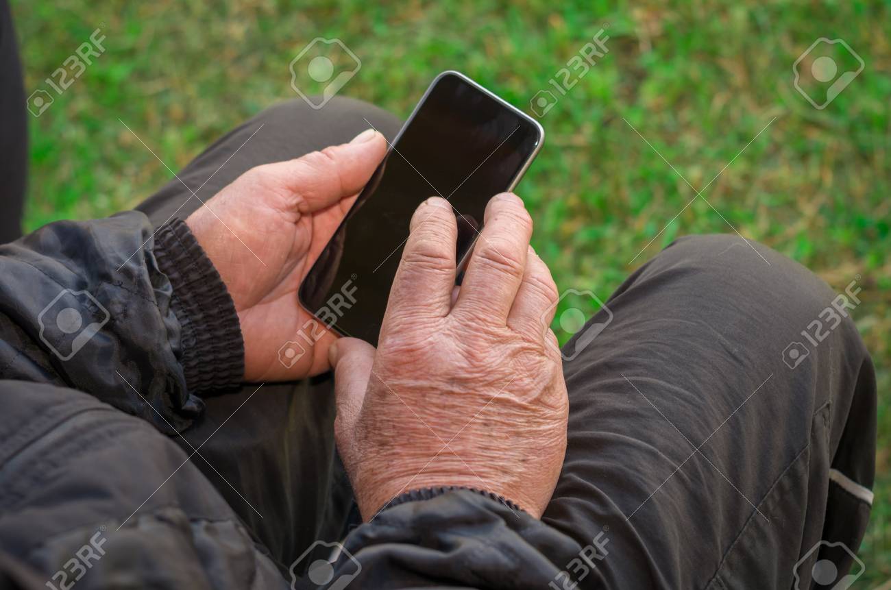 Close up of a wrinkled finger touching the smartphone, old man uses technology. Internet. - 98491849 Close up of a wrinkled finger touching the smartphone, old man uses technology. Internet. - 98491849