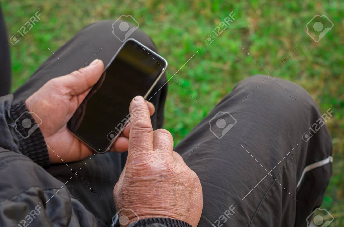 Close up of a wrinkled finger touching the smartphone, old man uses technology. Internet. - 98492082 Close up of a wrinkled finger touching the smartphone, old man uses technology. Internet. - 98492082