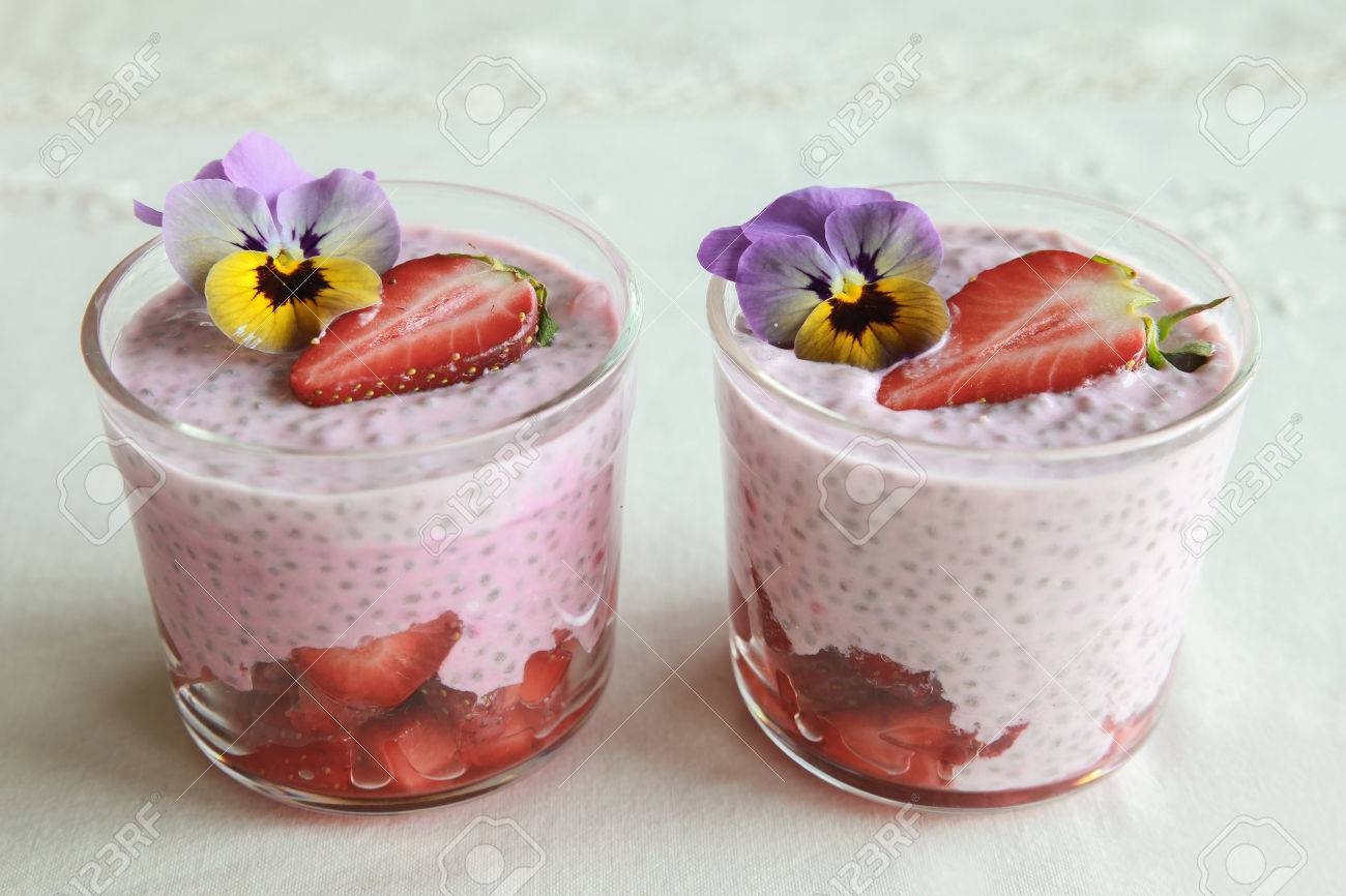 Homemade Pink Chia Pudding With Strawberry And Edible Flowers - 