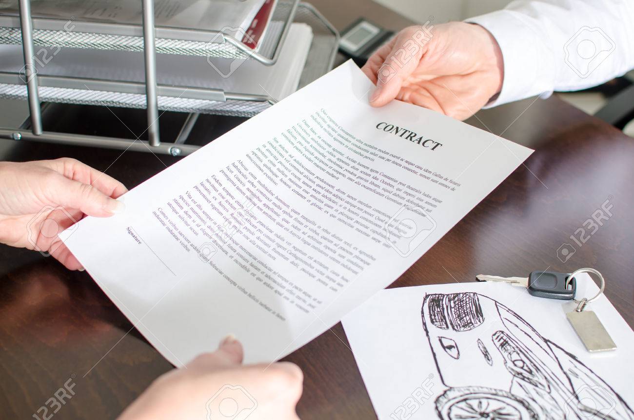 dealer showing a car purchase contract in car dealership stock photo car purchase contract