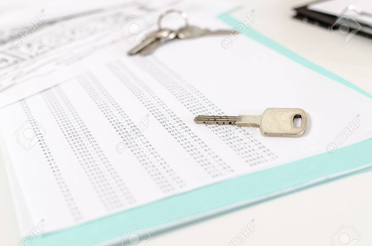house keys on an amortization schedule closeup stock photo picture