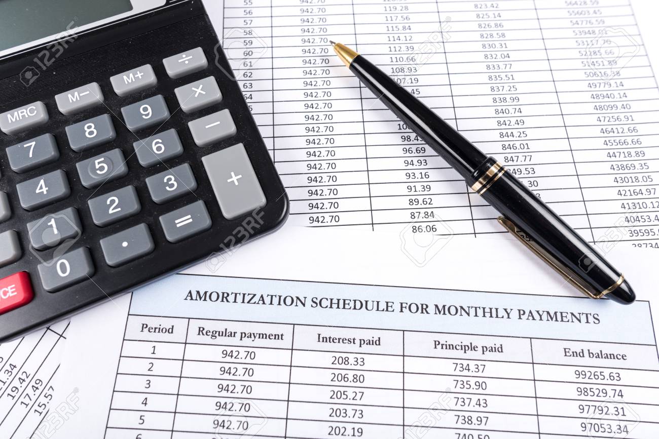 amortization schedule documents with calculator stock photo picture amortizatin schedule