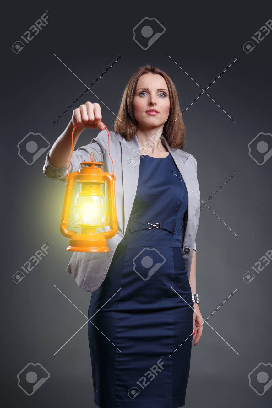 Studio portrait of a courageous and decided woman with the lantern - 24041958 Studio portrait of a courageous and decided woman with the lantern - 24041958