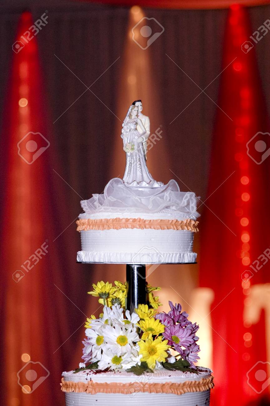 Double Layer White Wedding Cake With White Pink And Yellow Flowers