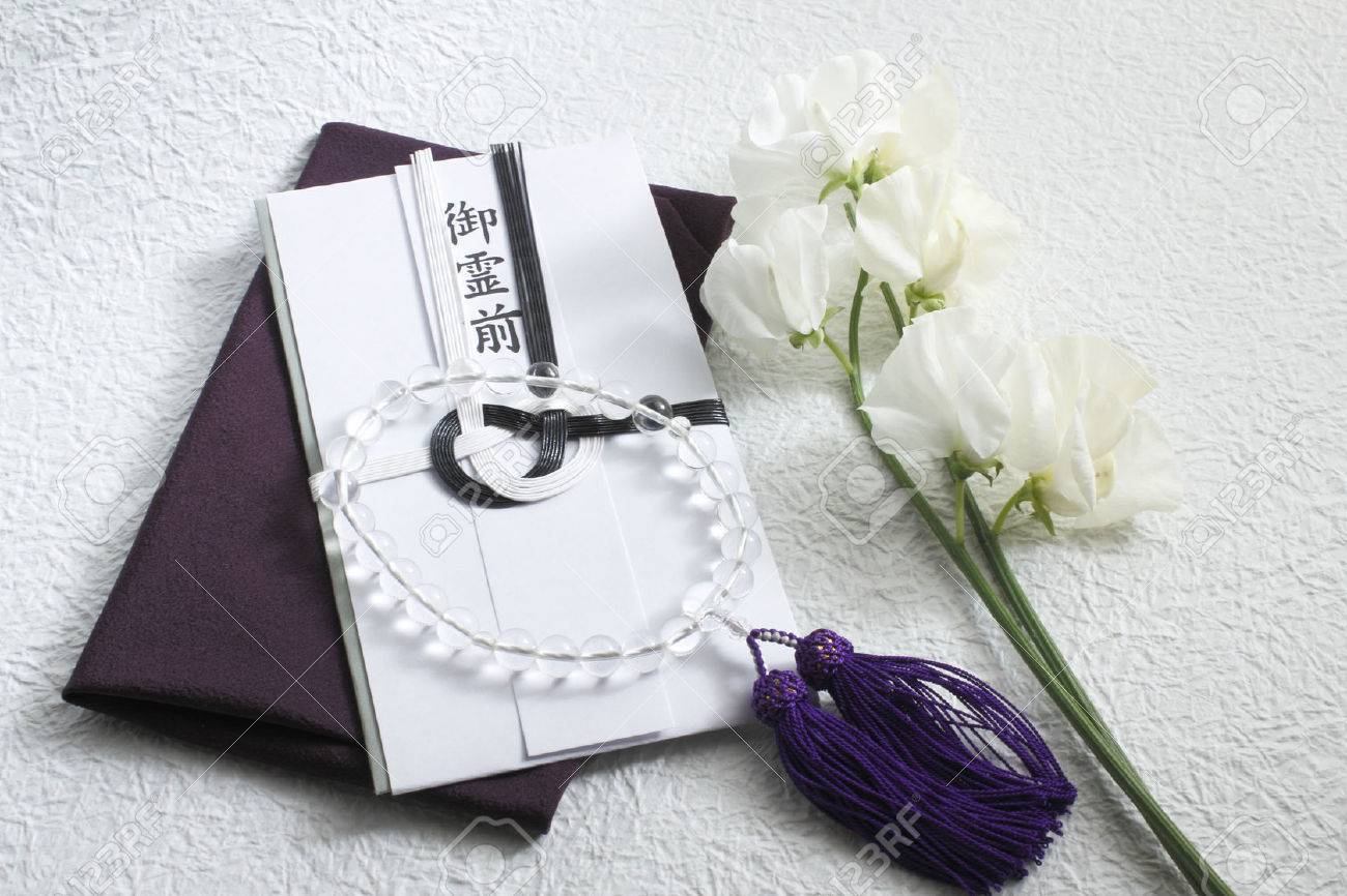 funeral gift bags and silk wrapper and prayer beads stock photo