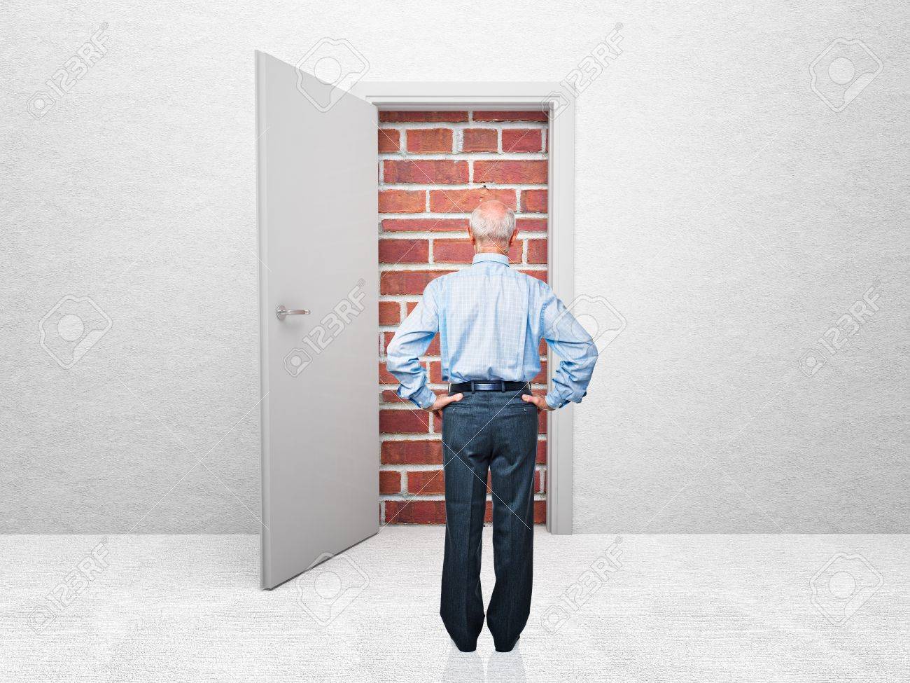 Standing Old Man And Door With Brick Wall