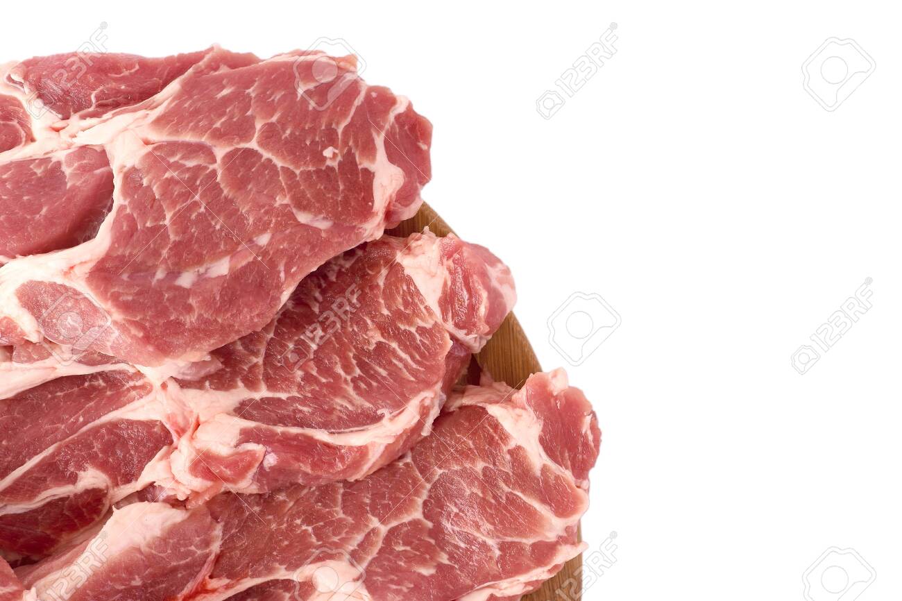 Raw and fresh sliced ​​pork meat laid out on a wooden round board, isolated on white background. Top view. - 156775358 Raw and fresh sliced ​​pork meat laid out on a wooden round board, isolated on white background. Top view. - 156775358