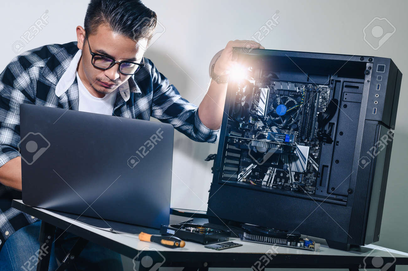 The technician repairing the computer. the concept of computer hardware, repairing, upgrade and technology. - 155504704 The technician repairing the computer. the concept of computer hardware, repairing, upgrade and technology. - 155504704