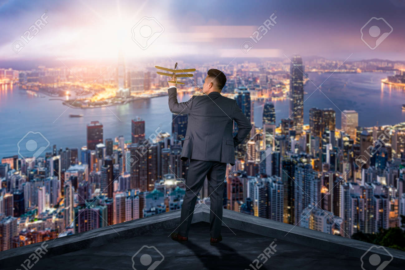 The double exposure image of the businessman standing back during sunrise overlay with cityscape image. The concept of modern life, business, city life and internet of things. - 155918021 The double exposure image of the businessman standing back during sunrise overlay with cityscape image. The concept of modern life, business, city life and internet of things. - 155918021