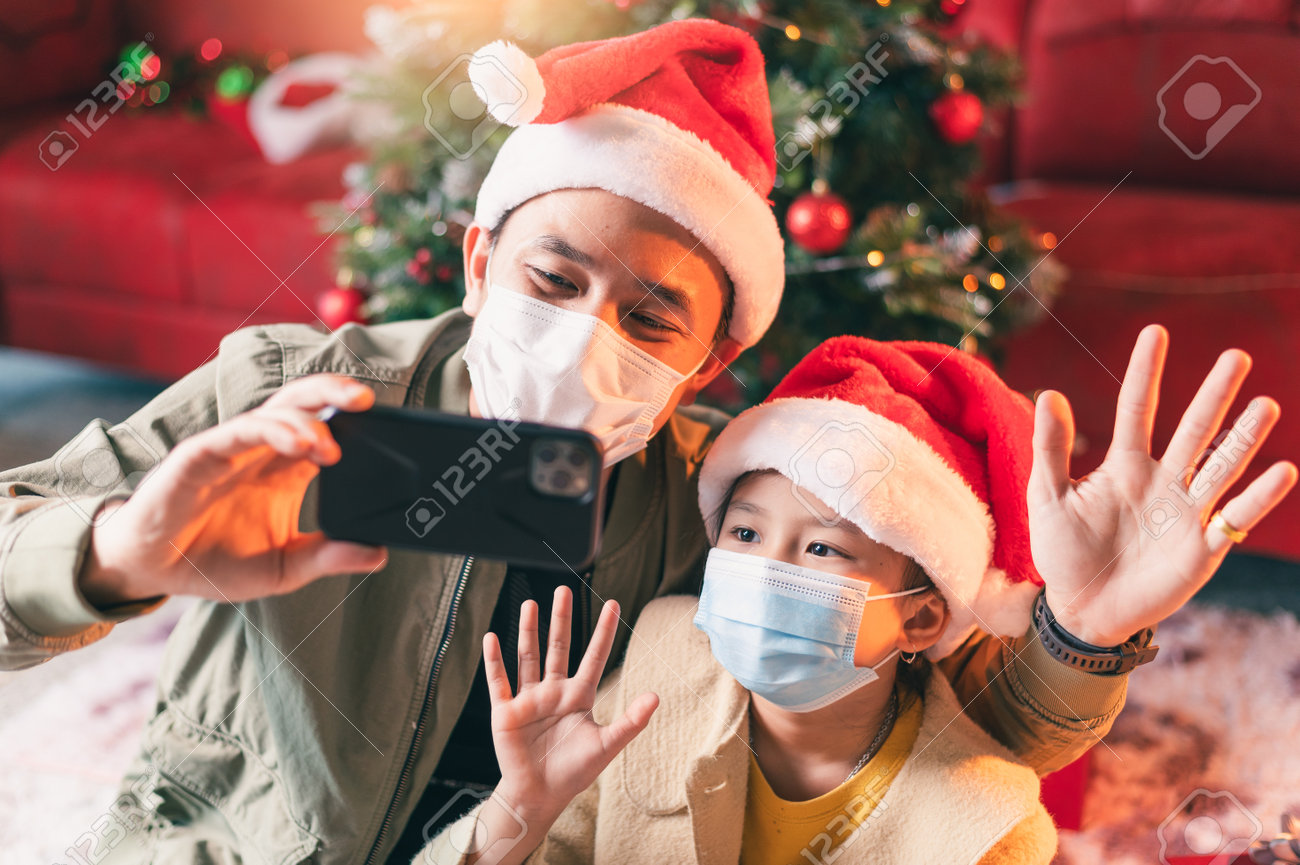the family celebrating Christmas festival during Coronavirus pandemic. the concept of Christmas, festival, Coronavirus, COVID-19 and health care - 160156481 the family celebrating Christmas festival during Coronavirus pandemic. the concept of Christmas, festival, Coronavirus, COVID-19 and health care - 160156481