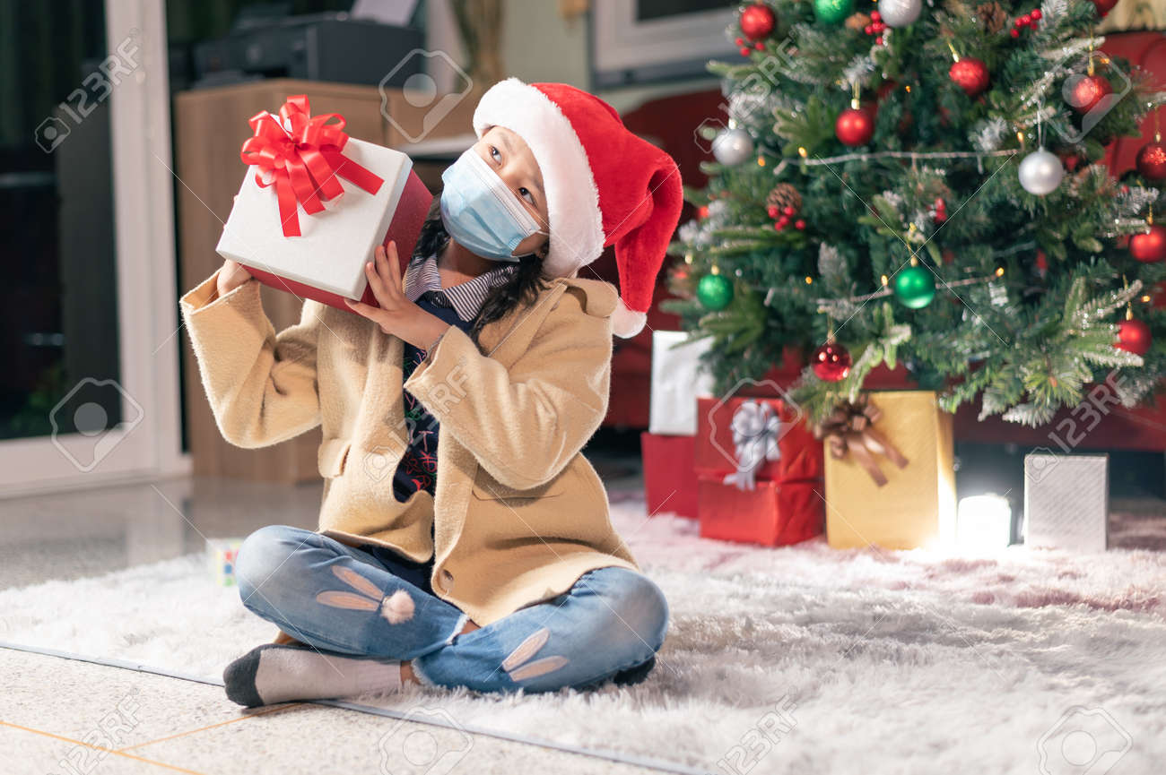 the girl open the girl box during the coronavirus pandemic. the concept of Christmas, boxing day, coronavirus pandemic and festival - 159612479 the girl open the girl box during the coronavirus pandemic. the concept of Christmas, boxing day, coronavirus pandemic and festival - 159612479