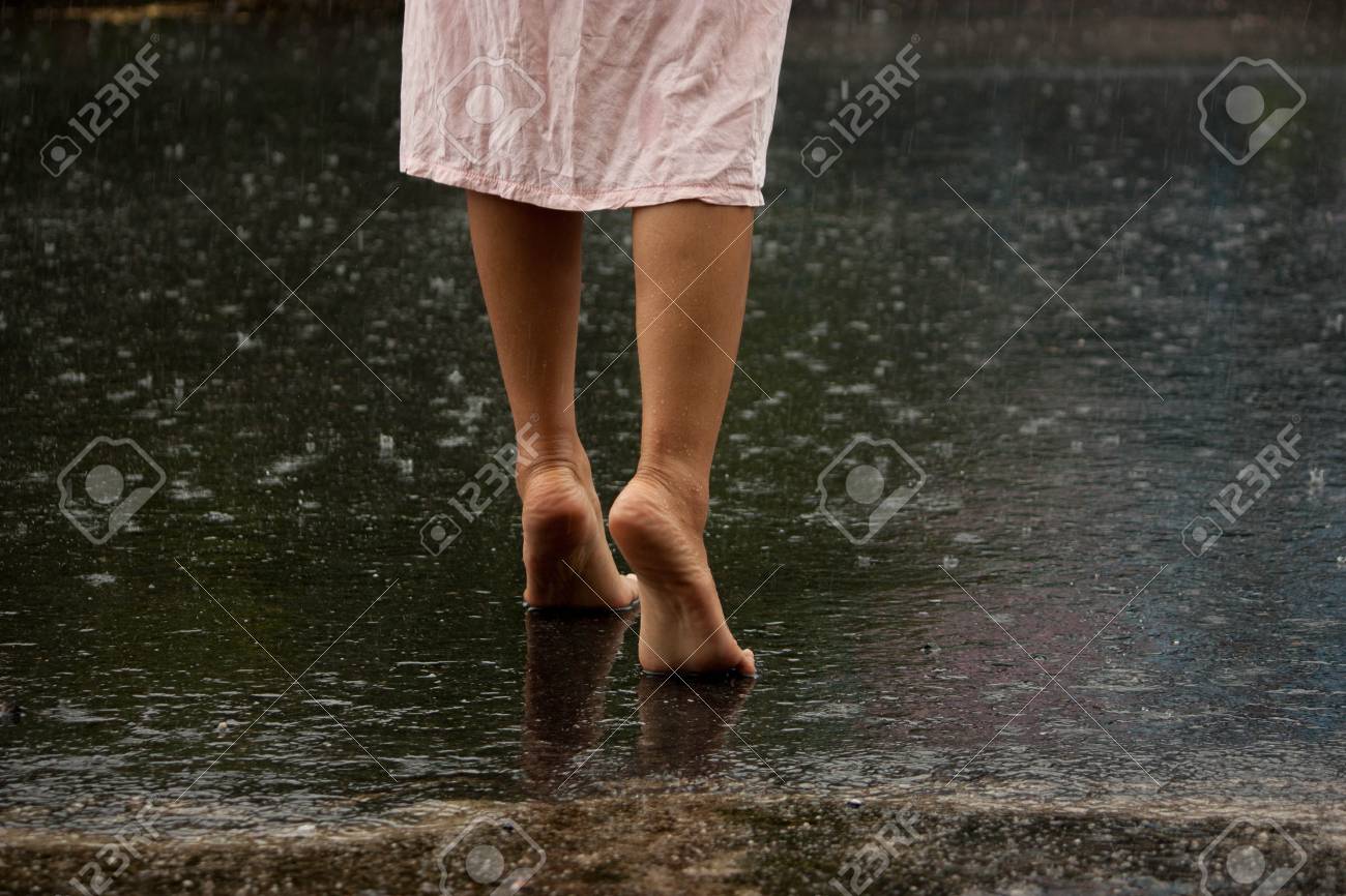 Young Lady Walking On The Ground After Rain Stock Photo Picture