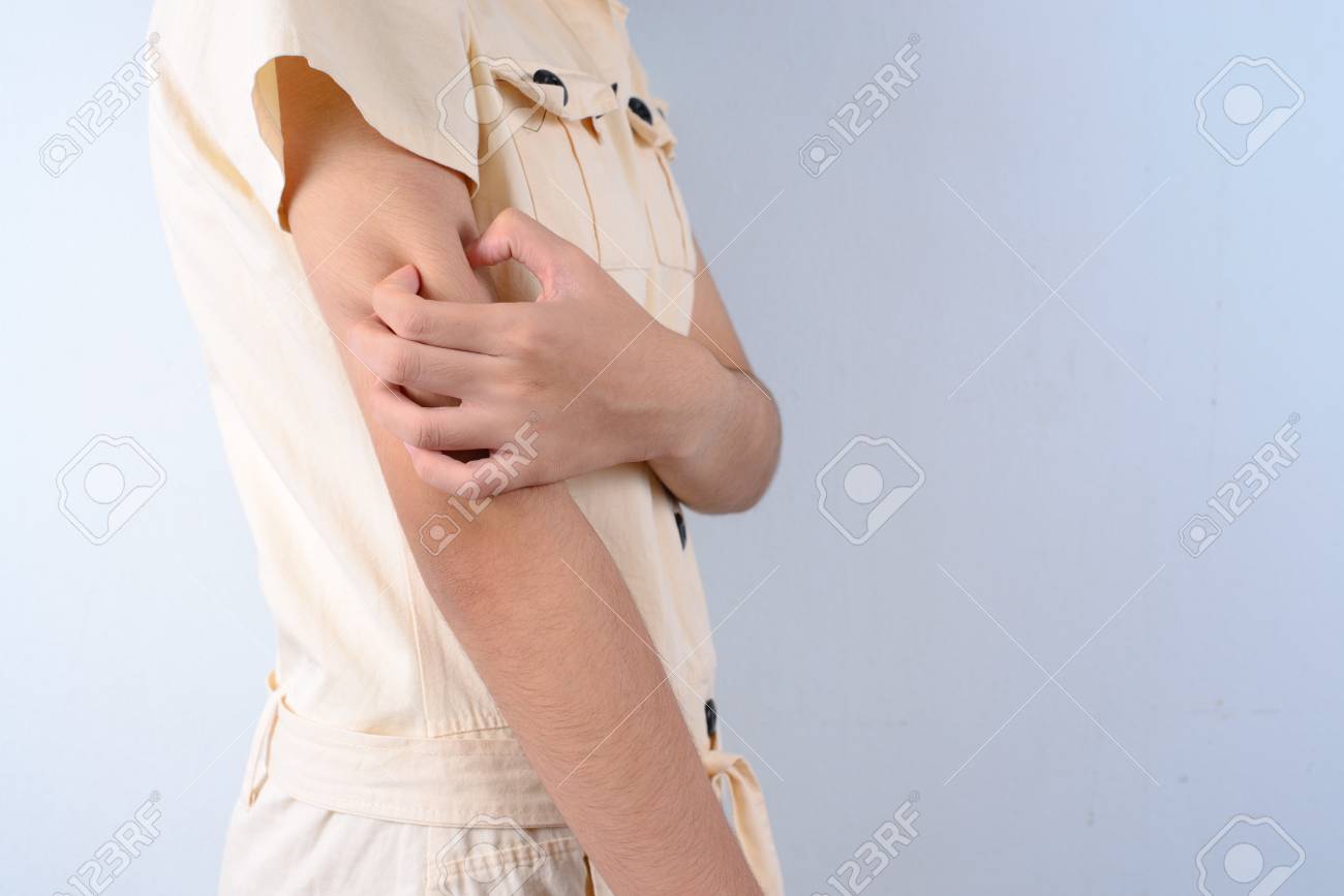 Beautiful girl scratching her arm. - 43654989 Beautiful girl scratching her arm. - 43654989