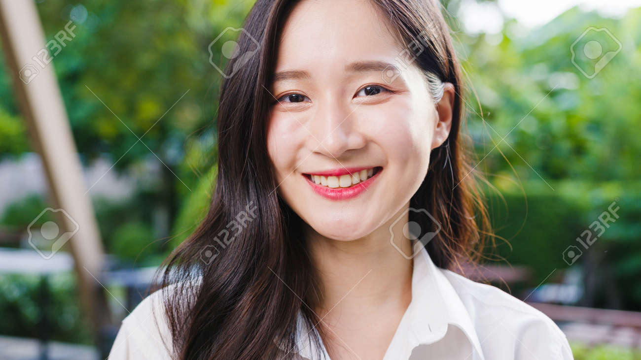 Happy young Asian female feeling happy smiling and looking to camera while relax on street in modern city. Lifestyle woman at outside house concept. - 171981311 Happy young Asian female feeling happy smiling and looking to camera while relax on street in modern city. Lifestyle woman at outside house concept. - 171981311