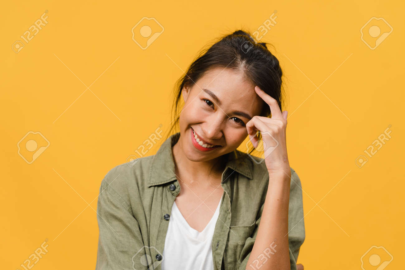 Young Asia Lady With Positive Expression, Smile Broadly, Dressed In Casual  Clothing And Looking At Camera Over Yellow Background. Happy Adorable Glad  Woman Rejoices Success. Facial Expression Concept. Stock Photo, Picture and