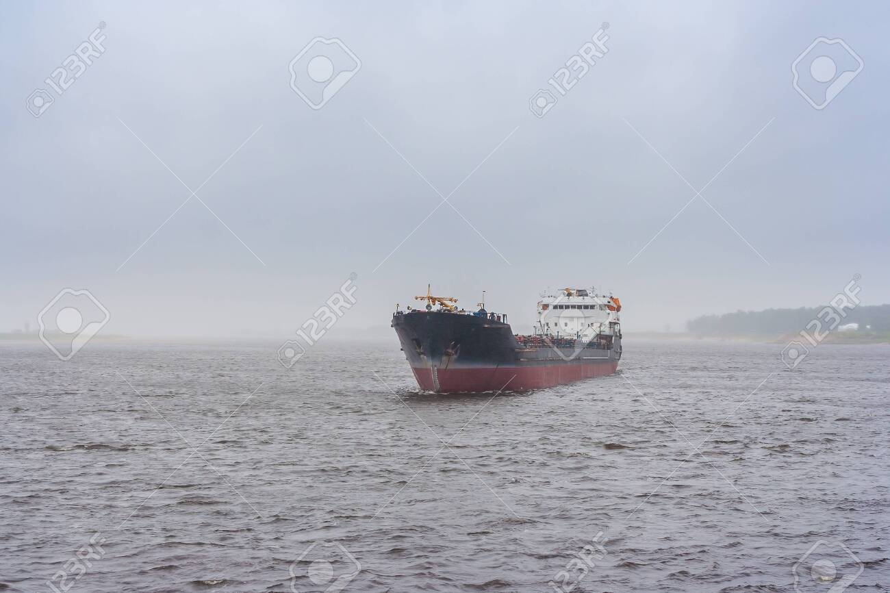 Cargo ship on the river in the fog - 144347375 Cargo ship on the river in the fog - 144347375