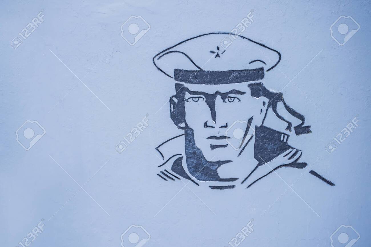 Image of a sailor at a war memorial, on a gray wall - 144546254 Image of a sailor at a war memorial, on a gray wall - 144546254