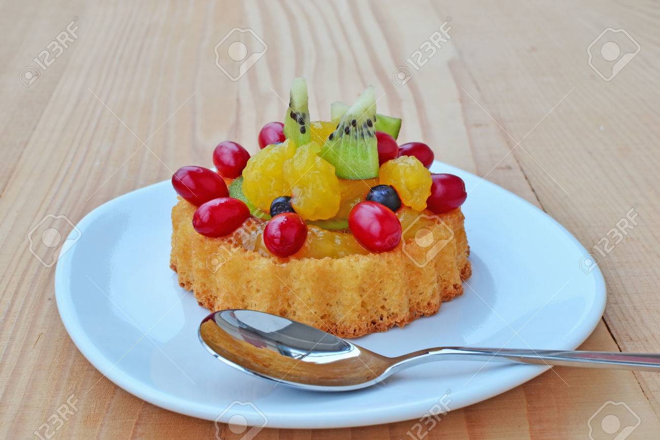 Dessert Sponge Cake Flan Filled With Forest Fruits Kiwi And Custard On Plate Over Wooden Table Stock Photo Picture And Royalty Free Image Image