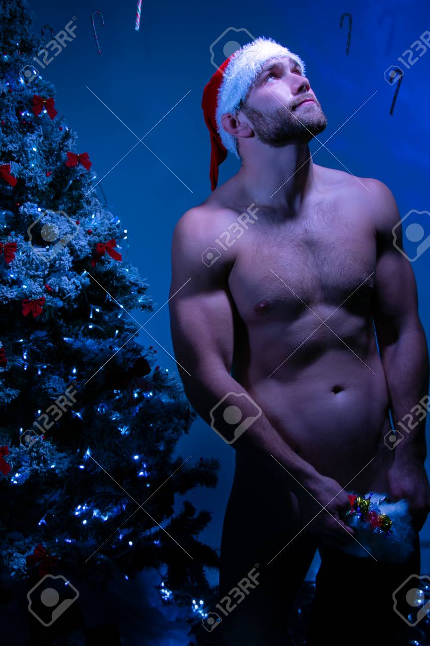 Hunky Nude Male Santa Wearing Just A Hat Holding Stocking Full Of Candy As  He Looked Up At The Moonlight Stock Photo, Picture And Royalty Free Image.  Image 112529599.