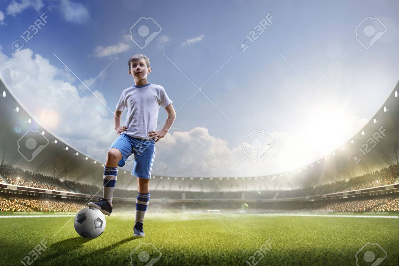 Childrens are playing soccer on grand arena in sunlights - 57366077 Childrens are playing soccer on grand arena in sunlights - 57366077