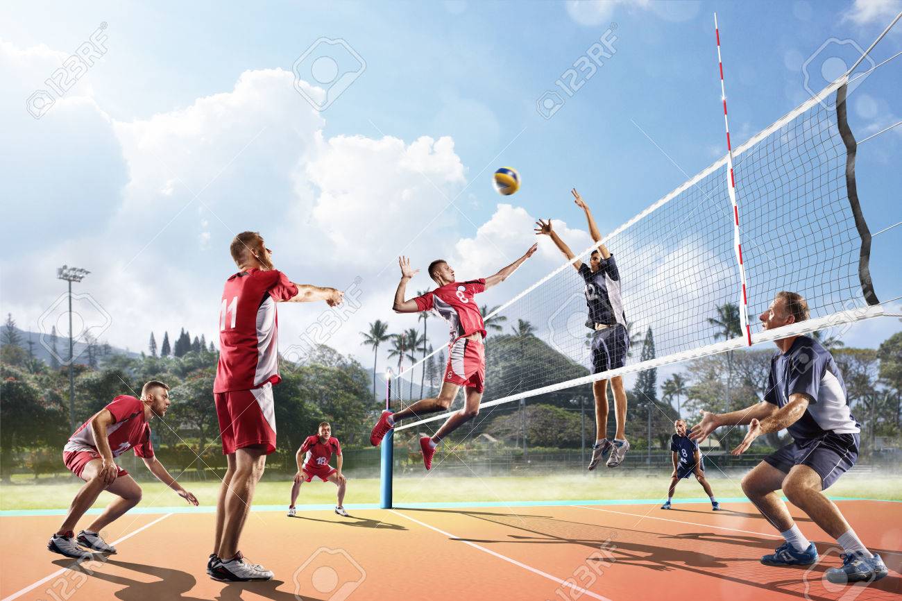 Professional volleyball players in action on the open air court - 62481645 Professional volleyball players in action on the open air court - 62481645