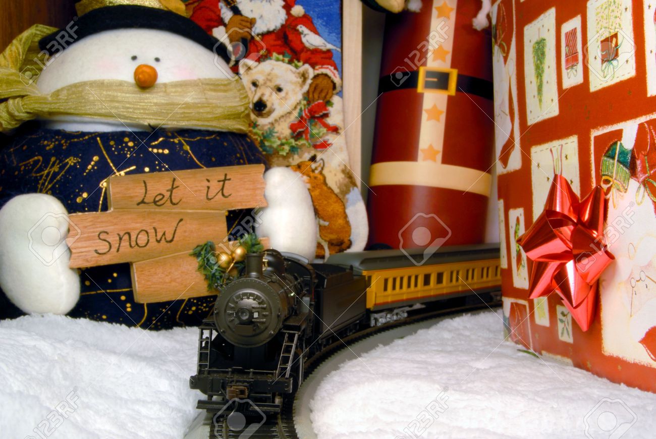 electric train and christmas decorations under tree stock photo electric train under christmas tree