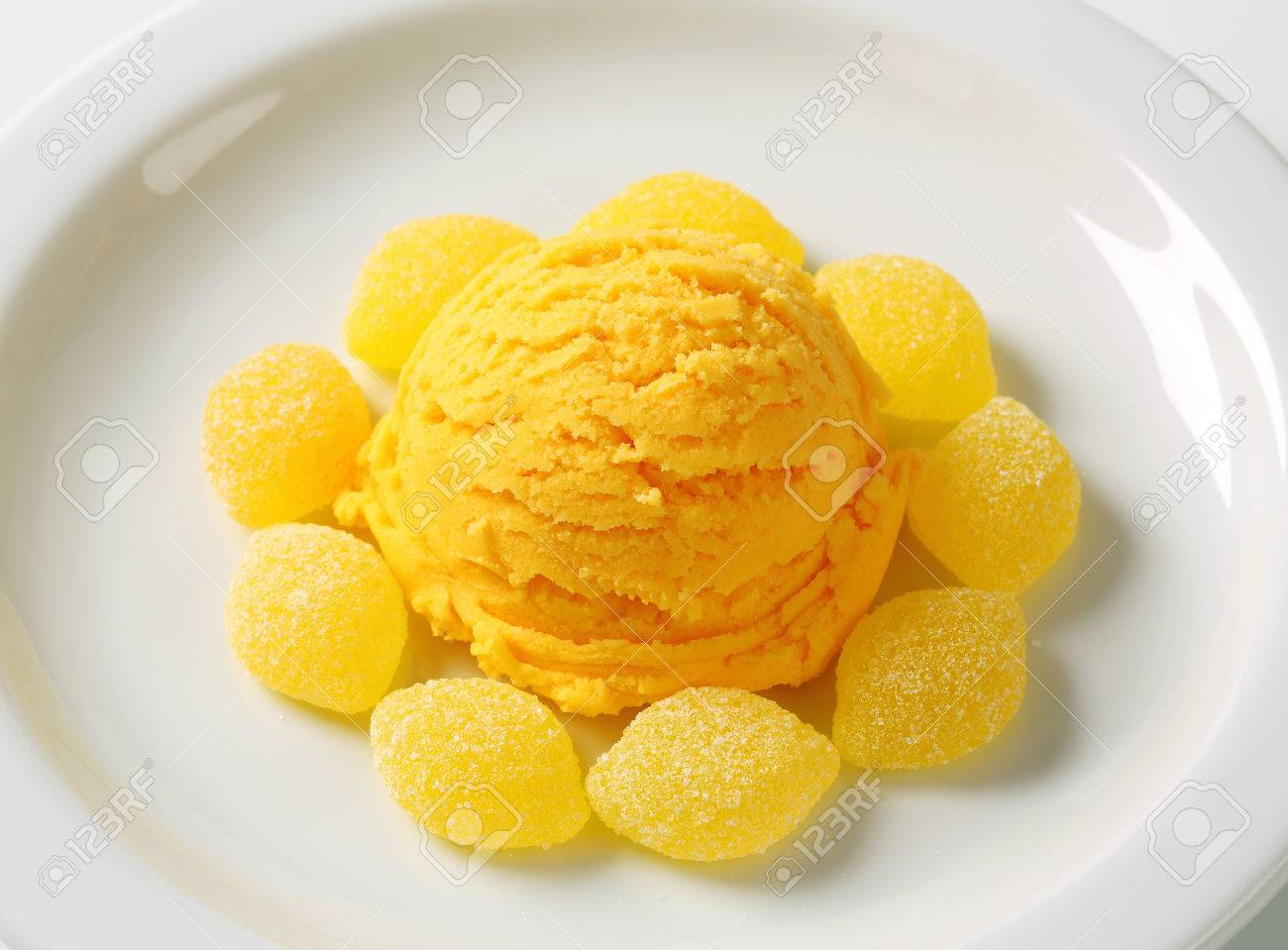 scoop of yellow ice cream with gelatin based candy stock photo